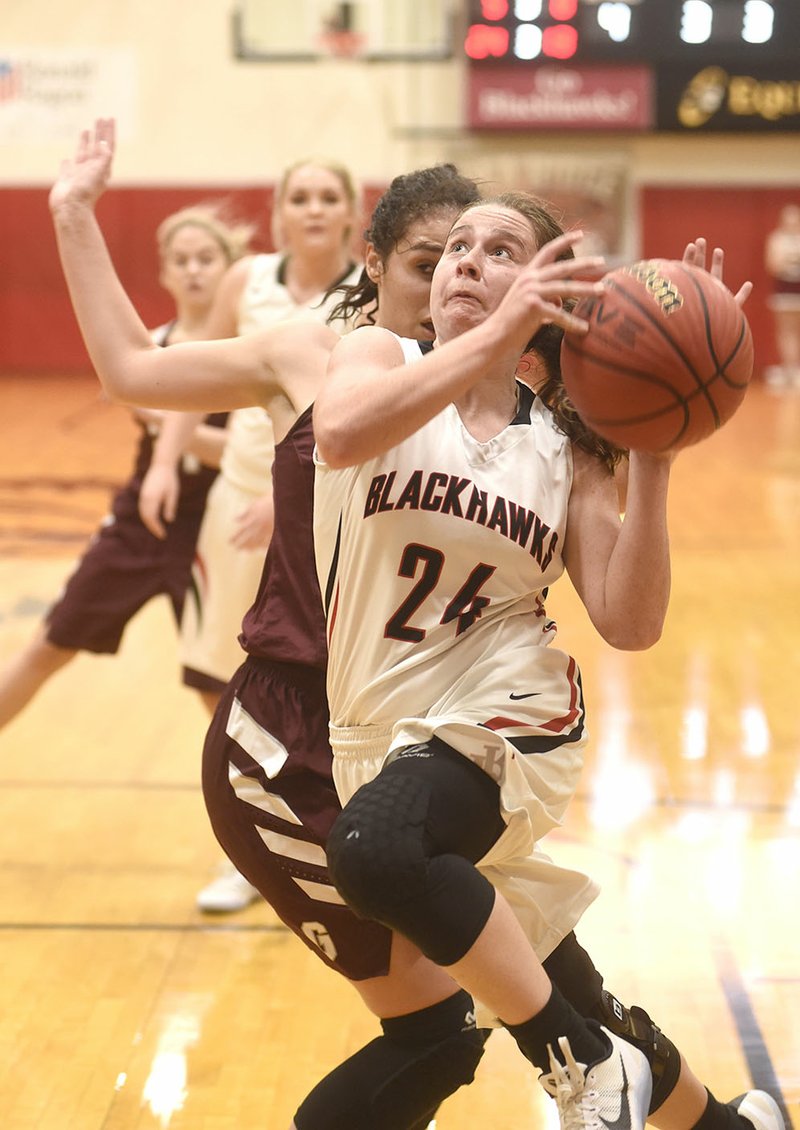 Pea Ridge point guard Jennifer Anthony (24) drives to the hoop past Gentry defender Hannah Boss (14) on Tuesday at Pea Ridge High School.