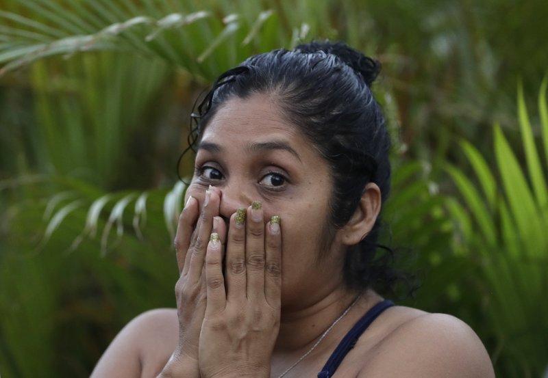 A woman reacts after being evacuated from Plaza Las Americas mall following reports of gunfire in Cancun, Mexico, Tuesday, Jan. 17, 2017. 