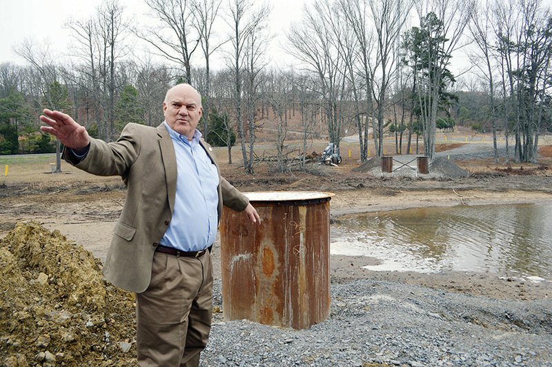 Jack Bell, chief of staff for the city of Conway, gestures as he describes the relocation of the historic Springfield-Des Arc bridge from near Wooster to Beaverfork Lake. The 1874 bowstring truss bridge was lifted off Cadron Creek on a remote road in Faulkner County and was refurbished by Workin’ Bridges of Iowa. The bridge will become a pedestrian bridge when it is placed on Beaverfork Lake sometime in February, Bell said.