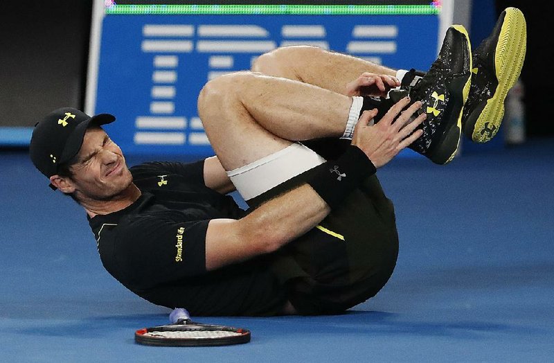 Andy Murray grimaces after turning his ankle during his second-round singles match against Andrey Rublev at the Australian Open on Wednesday. Murray won 6-3, 6-0, 6-2.
