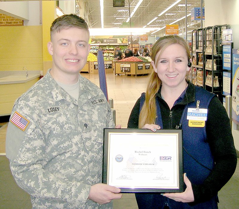 PHOTO SUBMITTED SPC Kody Losey, a representative of Employer Support of the Guard and Reserve, presents Rachel Bunch at the Jane Walmart with the Patriot Award.