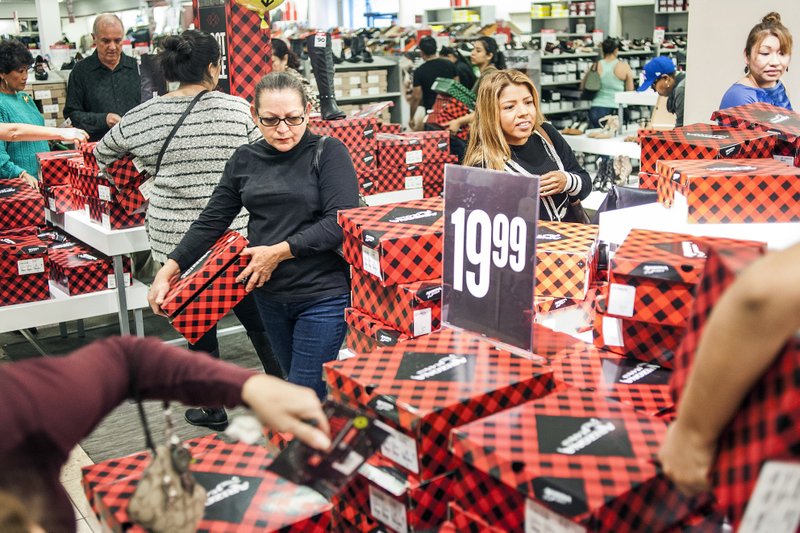 Shoppers peruse boots on sale at a J.C. Penney Co. store late last year in Laguna Hills, Calif. The Labor Department reported Wednesday that for all of 2016, prices were up 2.1 percent.