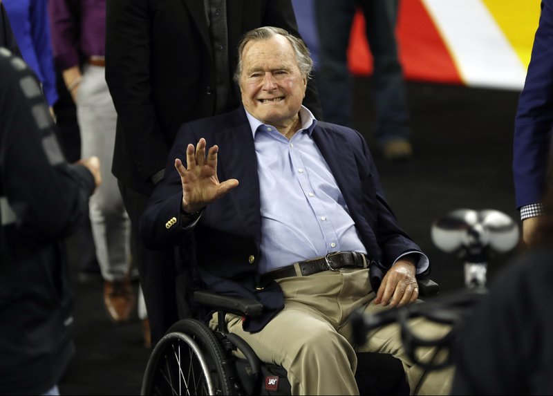  In this April 2, 2016, file photo, former President George H. W. Bush waves as he arrives at NRG Stadium before the NCAA Final Four tournament college basketball semifinal game between Villanova and Oklahoma in Houston. 