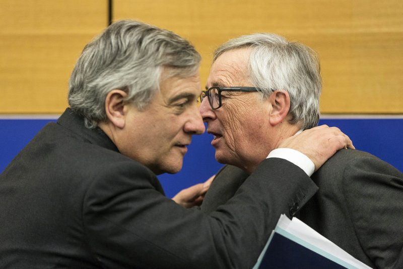 Newly elected president of the European Parliament, Antonio Tajani, left, hugs European Commission President Jean-Claude Juncker during a joint press conference at the European Parliament in Strasbourg, eastern France, Wednesday, Jan. 18, 2017. Tajani was elected president of the European Parliament on Tuesday. (AP Photo/Jean-Francois Badias)