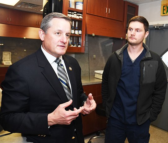 The Sentinel-Record/Mara Kuhn DROPPING BY: U.S. Rep. Bruce Westerman, left, R-District 4, speaks with Dr. Lance Smith, owner and pharmacist at Smith Drug and Compounding, and others during a visit Wednesday to Smith's business located at 1629 Airport Road, Suite D.