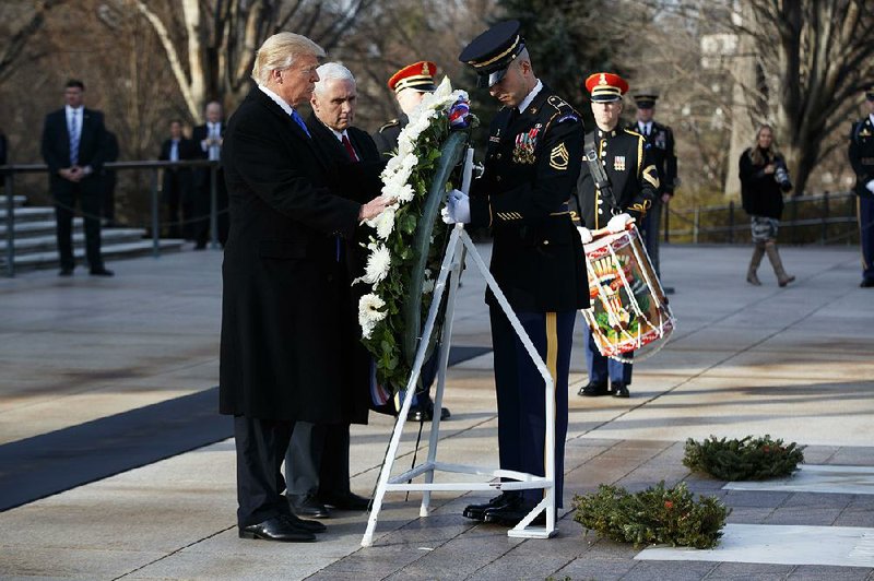 President-elect Donald Trump and Vice President-elect Mike Pence place a wreath Thursday at the Tomb of the Unknowns at Arlington National Cemetery in Virginia.