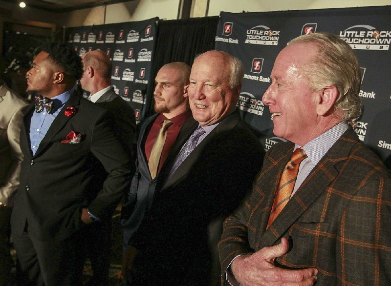 Former NFL quarterback Archie Manning (far right) jokes with Arkansas native and ex-NFL safety Cliff Harris (second from right) during the Little Rock Touchdown Club awards banquet Thursday night at the Embassy Suites in Little Rock. Manning, who spent 14 seasons in the NFL, was the keynote speaker for the event, which honored several high school and college football players and coaches.