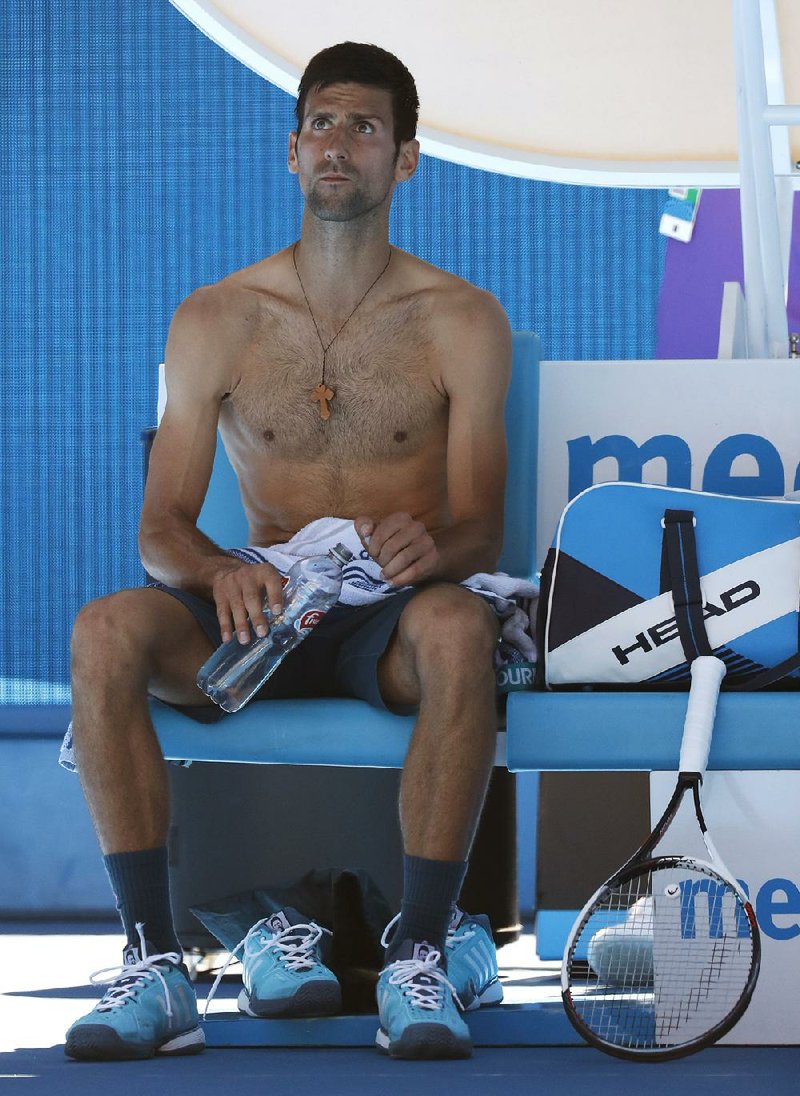 Serbia's Novak Djokovic rests during a break in play against Uzbekistan's Denis Istomin during their second round match at the Australian Open tennis championships in Melbourne, Australia, Thursday, Jan. 19, 2017. 
