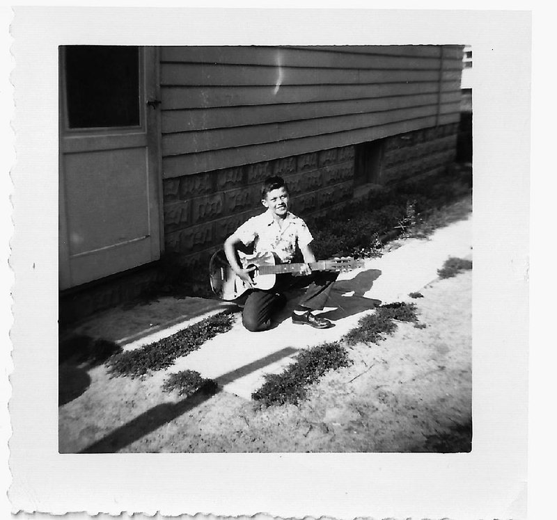 Young Robbie Robertson with his first guitar — one with a cowboy on it. He’d grow up to play guitar in The Band and collaborate with movie director Martin Scorsese.
