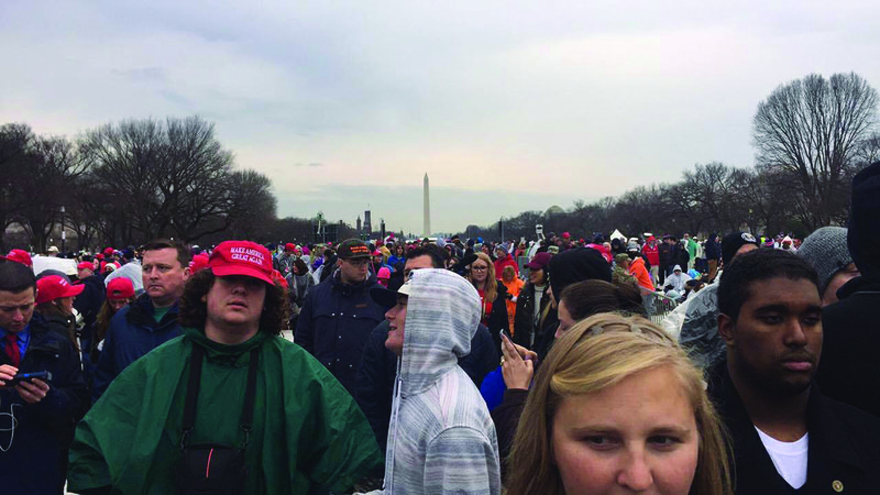 Presidential Support: A crowd of people, many wearing red “Make America Great” hats, await the beginning of the inauguration of President Donald Trump in Washington D.C. on Friday.
