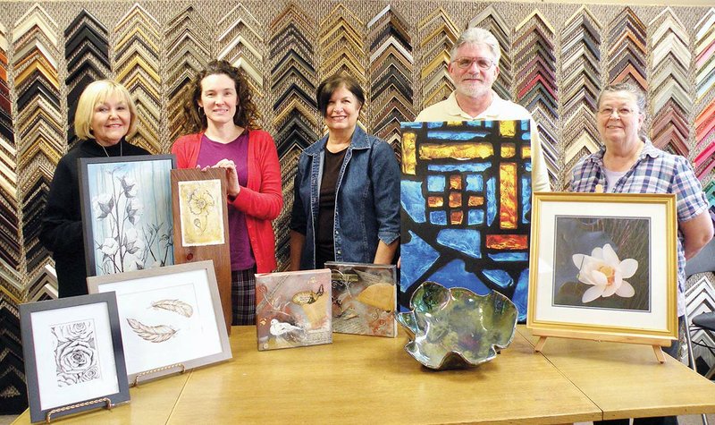 Pansy Westrich, left, co-chairwoman with Marianne Welch of the Art, Pray, Love fundraiser at St. Peter’s Episcopal Church in Conway, meets with four of the artists who will take part in the art show and sale Saturday. The artists include Jeanetta Darley, second from left, with her drawings and paintings depicting an agrarian theme; Susan Peterson, with two collages and a piece of raku pottery; Don Byram, with his photograph of a stained-glass window printed on canvas; and Dema Clark, with her photograph of a lotus blossom.