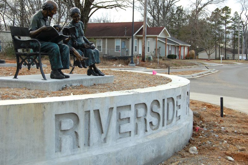 Several statues, like the own shown here of two elderly people reading to a young child, sit atop the entrance circle for the new Riverside Park in Benton. The grand opening for the park is set for April 1.