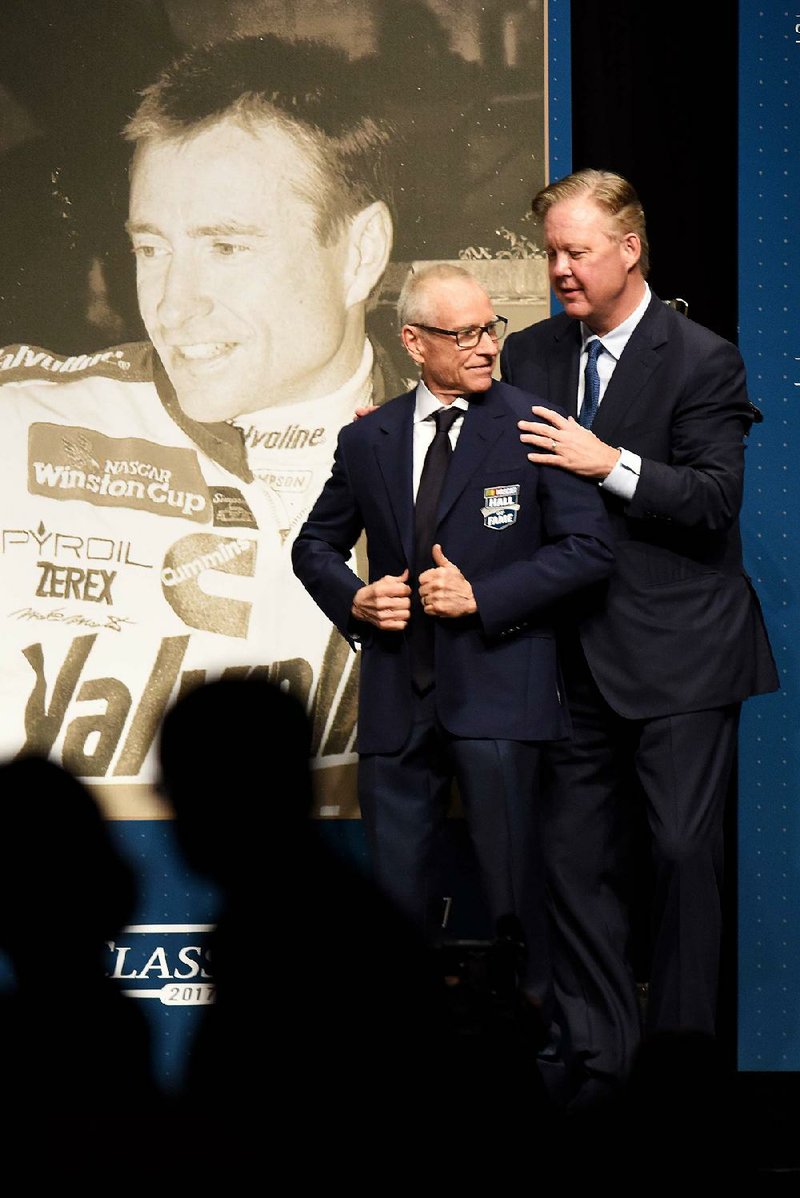 Retired NASCAR driver Mark Martin (left) of Batesville receives his Hall of Fame jacket from NASCAR CEO Brian France before Friday night’s induction ceremony in Charlotte, N.C.