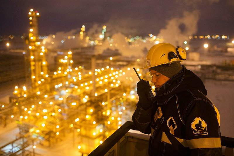 A worker monitors a unit of the Novokuibyshevsk oil refinery in the Samara region of Russia. Russia has reduced the amount of oil it pumps each day. 