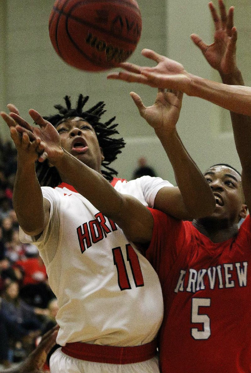 Maumelle’s John Word (11) and Little Rock Parkview’s Larodrius Terry battle for a rebound Friday during the Hornets’ 61-60 victory over the Patriots in Maumelle.