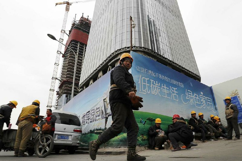 Workers break for lunch outside a construction site in Beijing late last year. Government spending and real estate sales supported China’s growth in the latest quarter, government data showed Friday. 