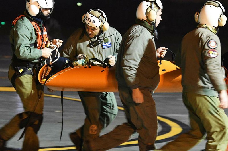 One of the four children rescued from the avalanche-hit Rigopiano Hotel is taken to a hospital Friday in Pescara, Italy. One rescued girl asked for cookies. 