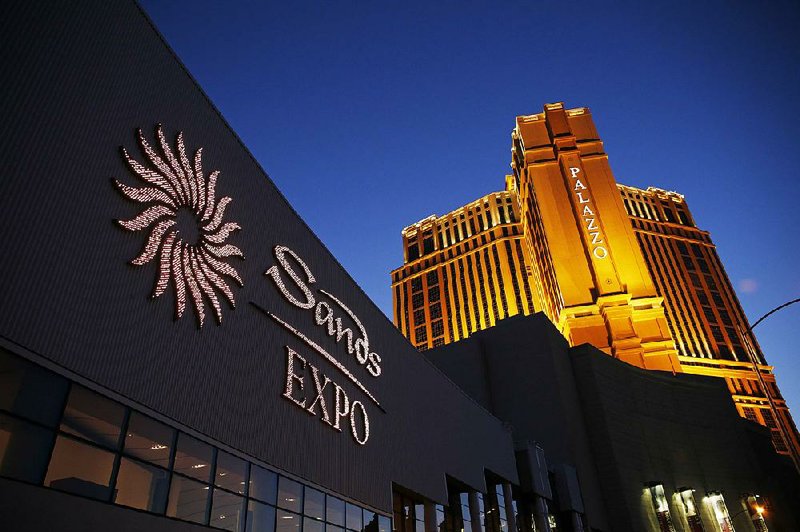 The Sands Expo and Convention Center and the Palazzo, owned by casino company Las Vegas Sands Corp., are shown in this file photo. The company on Friday agreed to pay $6.96 million to end two corruption investigations. 