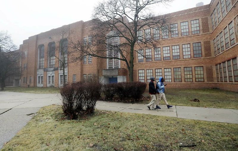 Students walk outside Pershing High School on Friday in Detroit. Pershing is one of the schools Michigan plans to close because of academic failures. 