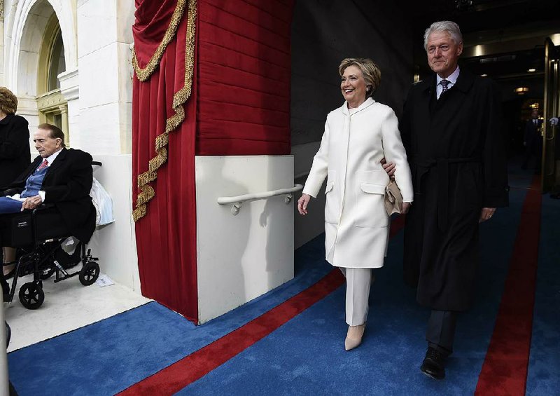 Former President and first lady Bill and Hillary Clinton arrive for Friday’s inauguration. At the inaugural luncheon later, Hillary Clinton received a standing ovation after President Donald Trump asked her to rise. 