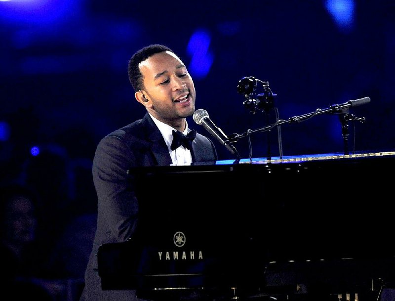 In this Feb. 8, 2013, file photo, John Legend performs onstage at the Los Angeles Convention Center in Los Angeles. 