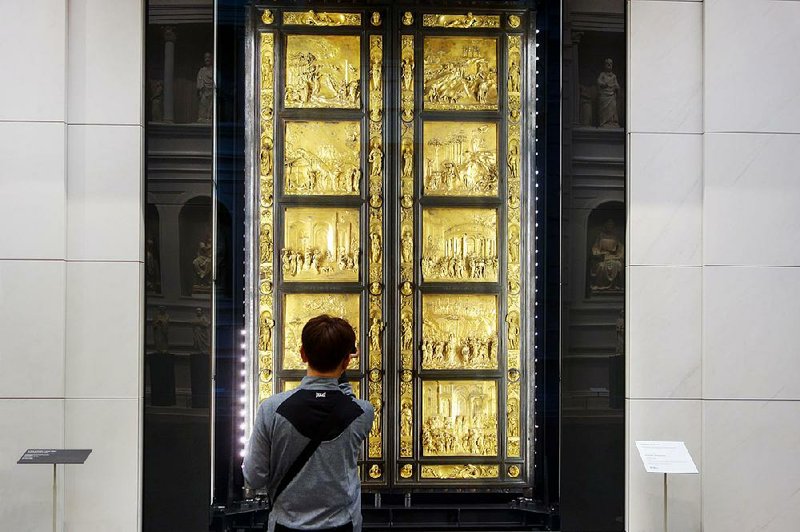A visitor admires Lorenzo Ghiberti’s Gates of Paradise in Florence’s newly refurbished Duomo Museum.