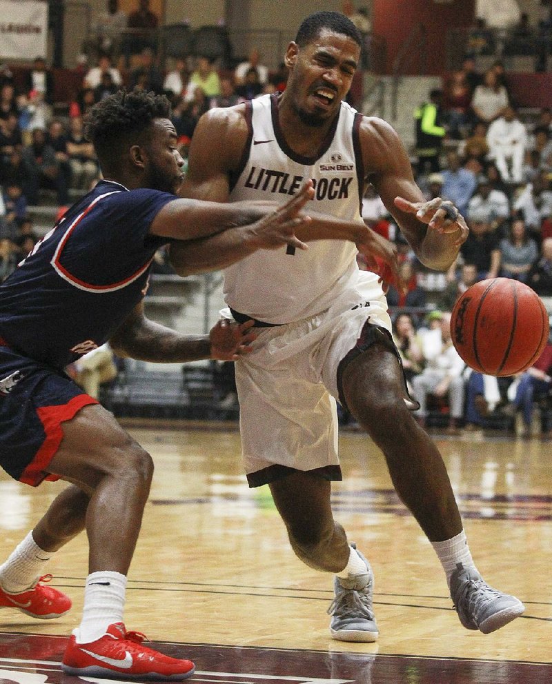 UALR’s Jalen Jackson (right) is fouled by South Alabama’s Shaq Calhoun during Saturday afternoon’s game at the Jack Stephens Center in Little Rock.