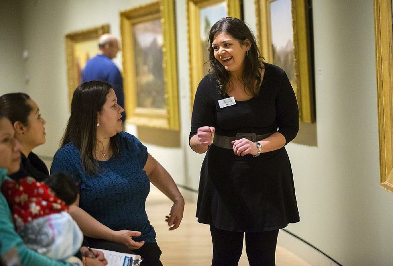 At Crystal Bridges Museum of American Art in Bentonville, Emily Rodriguez (right), associate museum educator, leads a discussion last week with people from the Springdale Family Literacy Program. 
