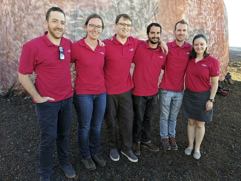 Scientists Joshua Ehrlich (from left), Laura Lark, Sam Payler, Brian Ramos, James Bevington and Ansley Barnard pose Thursday before entering the geodesic dome that they will call their Martian home for the next eight months. 