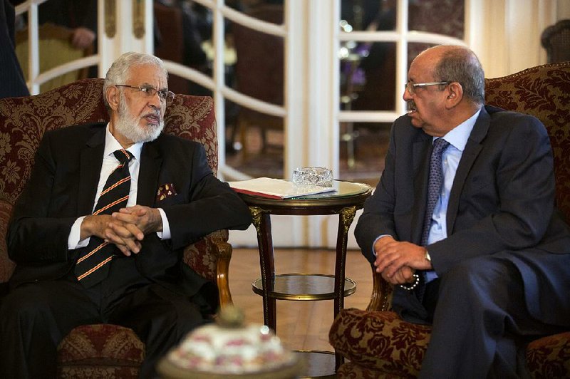 Libyan Foreign Minister Mohamed Taher Siala (left) and Abdelkader Messahel, Algeria’s minister for African and Maghreb affairs, talk Saturday in Cairo during a ministerial meeting of countries that border Libya.