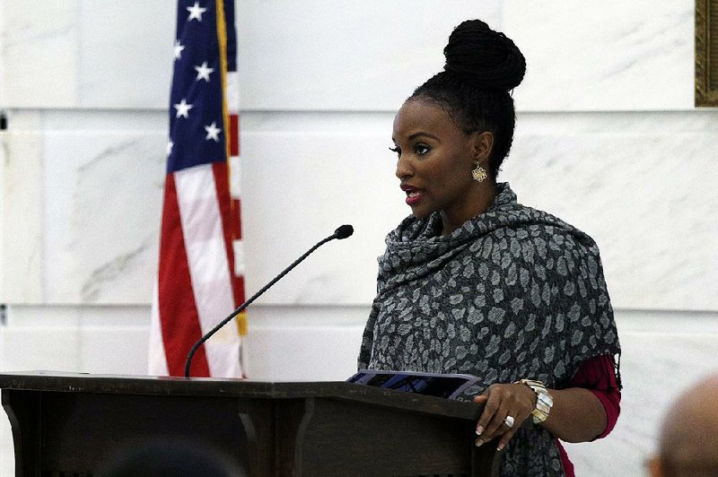 Tionna Jenkins with the Clinton Health Matters Initiative speaks Friday at the state Capitol during a state Fair Housing Commission news conference.