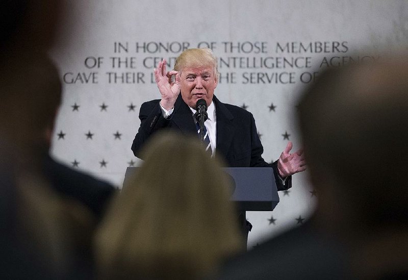 President Donald Trump visits the CIA headquarters in Langley, Va., where he told members of the intelligence community, “I am so behind you.”