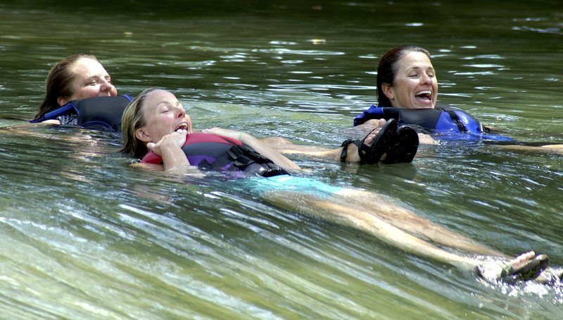 File Photo/NWA Democrat-Gazette/RANDY MOLL Robyn Nolen (left), Kerri Vollmer and Amy Witte float over the Illinois River rapids at the Siloam Springs Kayak Park on July 21. Arkansas groups spent about $600,000 on a river study using samples from 35 sites over two years. An independent third-party was used to prevent bias, said Ryan S. King, the Baylor University professor who led the study.