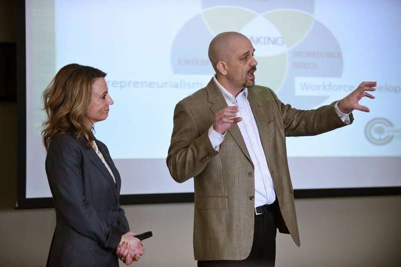 Megan Bolinder, dean of the communications and arts at Northwest Arkansas Community College, and Keith Peterson, dean of workforce development, make a presentation Saturday in the Shewmaker Center for Global Business Development in Bentonville.