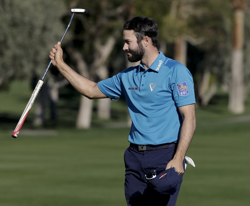 Adam Hadwin celebrates on the 18th hole after shooting a 59 to take the third round lead in the CareerBuilder Challenge golf tournament at La Quinta Country Club Saturday, Jan. 21, 2017, in La Quinta, Calif. (AP Photo/Chris Carlson)