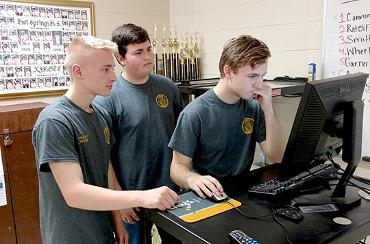 Submitted photo Hot Springs World Class High School Navy JROTC Cadets, from left, Garrett Cannon, Jackson Ratcliff and Charles Bays participate in the state level of the CyberPatriot competition on Jan. 13. CyberPatriot is a national youth cyber education program sponsored by the Air Force Association. The competition puts teams of high school and middle school students in the position of newly hired information technology professionals tasked with managing the network of a small company. Teams are given a set of virtual images that represent operating systems and are tasked with finding cybersecurity vulnerabilities within the images and correcting the system while maintaining critical services. Teams compete for the top placement within their state and region. The nation's top teams earn all-expenses paid trips to Baltimore, Md., for the national finals. CyberPatriot was conceived by the AFA to inspire students toward careers in cybersecurity or other science, technology, engineering, and mathematics disciplines. CDR Jeff King said Cannon took the school lead in the program.