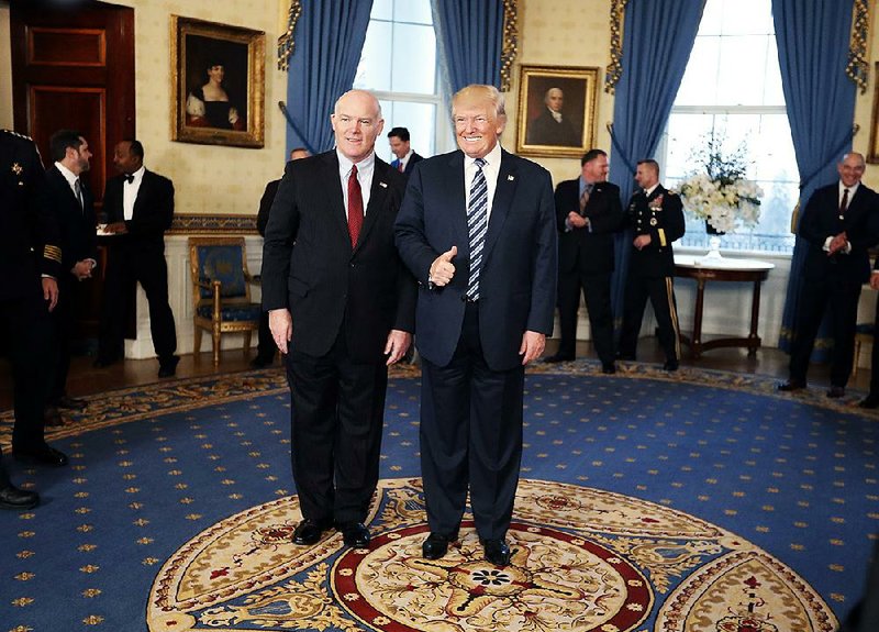 Secret Service Director Joseph Clancy stands with President Donald Trump during a reception for inaugural law enforcement officers and first responders in the Blue Room of the White House on Sunday in Washington.