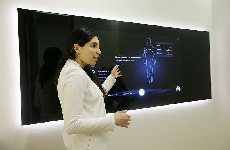 Dr. Aaliya Yaqub points to a monitor while giving a medical checkup demonstration at a Forward health office in San Francisco.