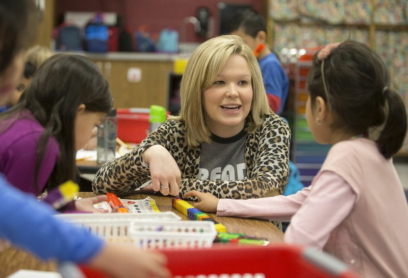 Natalie McKeel, teacher, works Friday with Valentina Sanchez-Gonzalez on a math problem in her kindergarten class at Reagan Elementary School in Rogers.