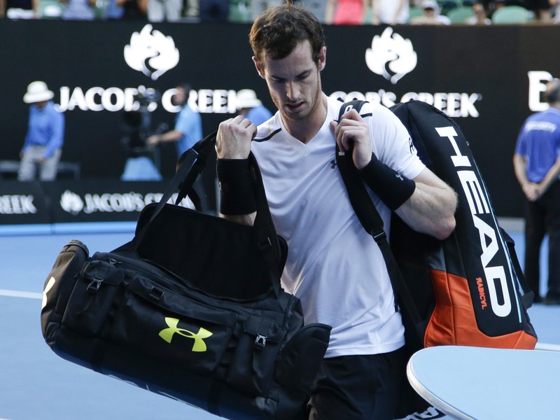 Britain's Andy Murray carries his bags from the court following his fourth round loss to Germany's Mischa Zverev at the Australian Open tennis championships in Melbourne, Australia, Sunday, Jan. 22, 2017. 