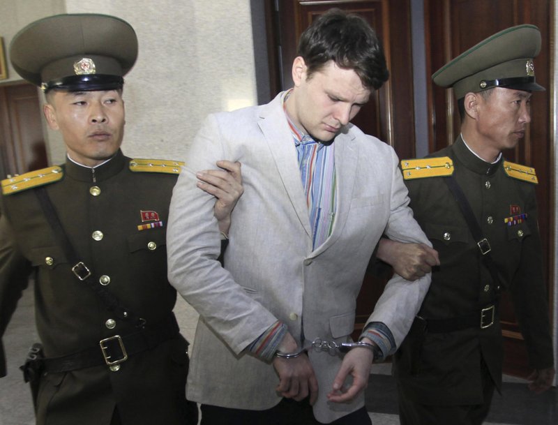 FILE - In this March 16, 2016, file photo, American student Otto Warmbier, center, is escorted at the Supreme Court in Pyongyang, North Korea. 