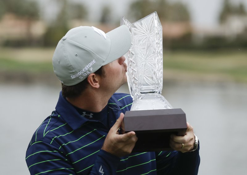 The Associated Press SWAFFORD'S FIRST WIN: Hudson Swafford kisses the trophy after winning the CareerBuilder Challenge golf tournament at 20-under par on the Stadium Course at PGA West, Sunday in La Quinta, Calif.