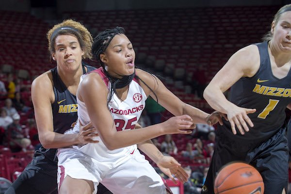 Arkansas senior Alecia Cooley loses control of the ball while being defended by Missouri junior Bir Porter (left) and senior Lianna Doty on Monday, Jan. 23, 2017, at Bud Walton Arena in Fayetteville.