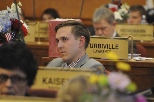 In this Wednesday, Jan. 18, 2017 photo, Republican Rep. Mathew Wollmann sits on the House floor in Pierre, S.D.