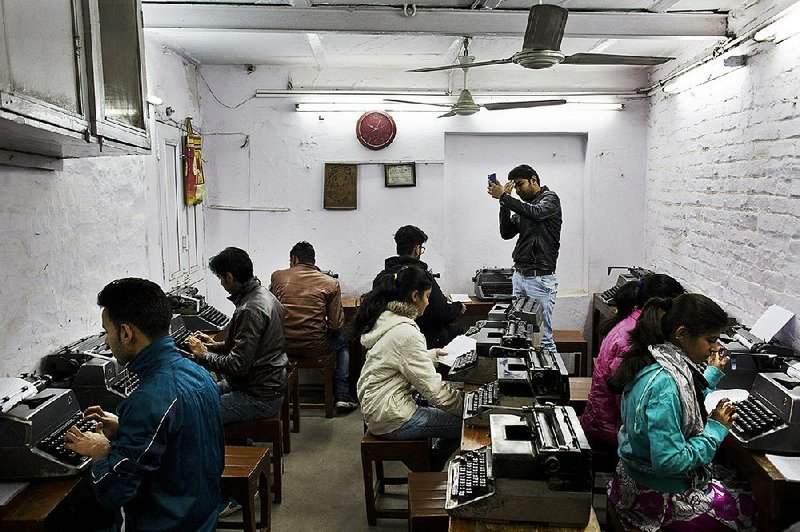 Students practice last week at a typing school in New Delhi. A few thousand professional typists continue to find work in India, where the typewriter once was considered a symbol of education and women’s growing independence.