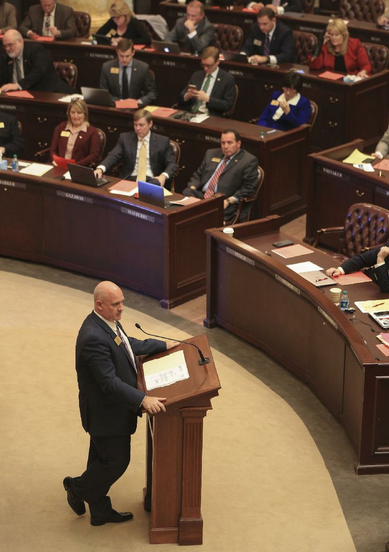Rep. Mathew Pitsch speaks Monday on the House floor as he presents the governor’s tax-cut bill.