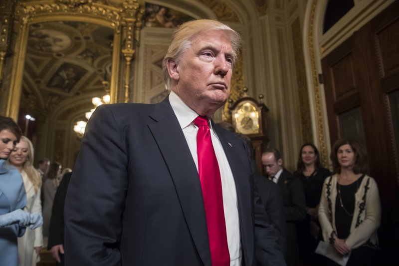 FILE - In this Friday, Jan. 20, 2017, file photo, President Donald Trump leaves the President's Room of the Senate at the Capitol after he formally signed his cabinet nominations into law, in Washington. 