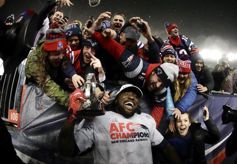 The Associated Press SUPER BOWL BOUND: New England Patriots running back LeGarrette Blount holds the AFC championship trophy surrounded by fans after the AFC championship game, Sunday in Foxborough, Mass. The Patriots defeated the the Pittsburgh Steelers 36-17 to advance to the Super Bowl.