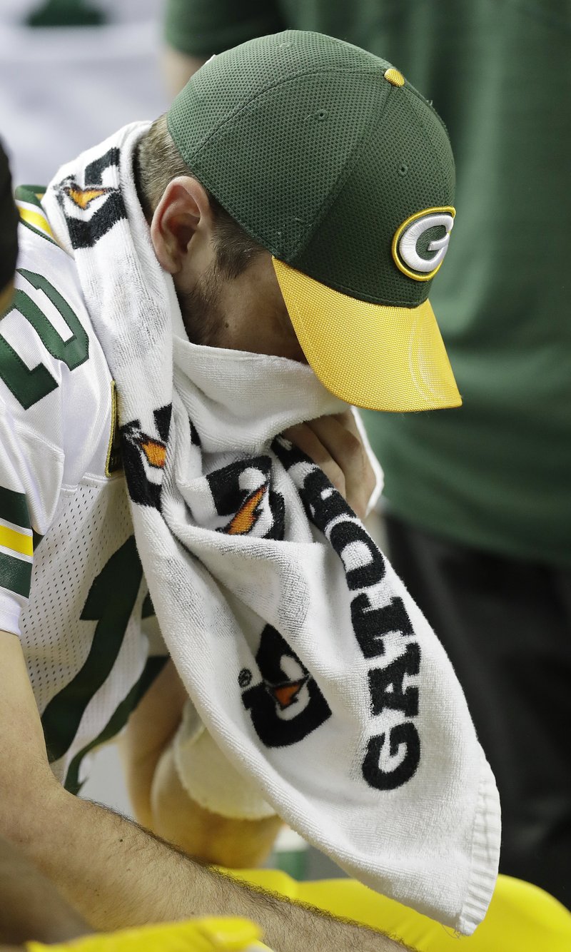 The Associated Press HAVING A BAD DAY: Green Bay Packers' Aaron Rodgers wipes his face on the bench during the first half of the NFC championship game against the Atlanta Falcons Sunday in Atlanta. The Falcons won 44-21.