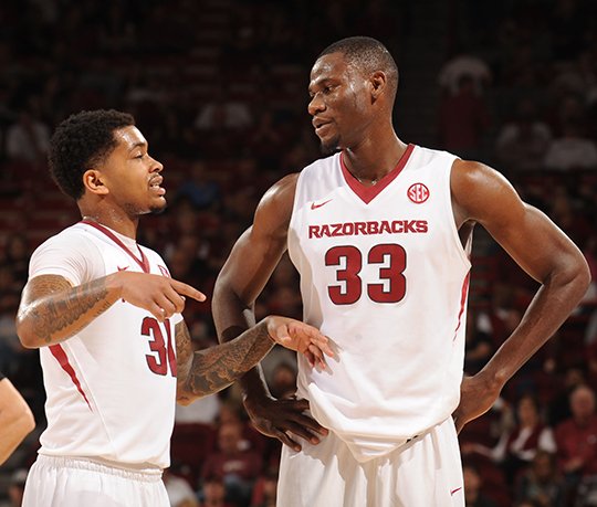 NWA Democrat-Gazette/ANDY SHUPE TALK IT OUT: Moses Kinglsey (33) of Arkansas speaks with Anton Beard (31) against LSU Saturday during the second half of play in Bud Walton Arena. Talk on the court will be key tonight with both teams' benches on opposite baselines at Vanderbilt's Memorial Gym.